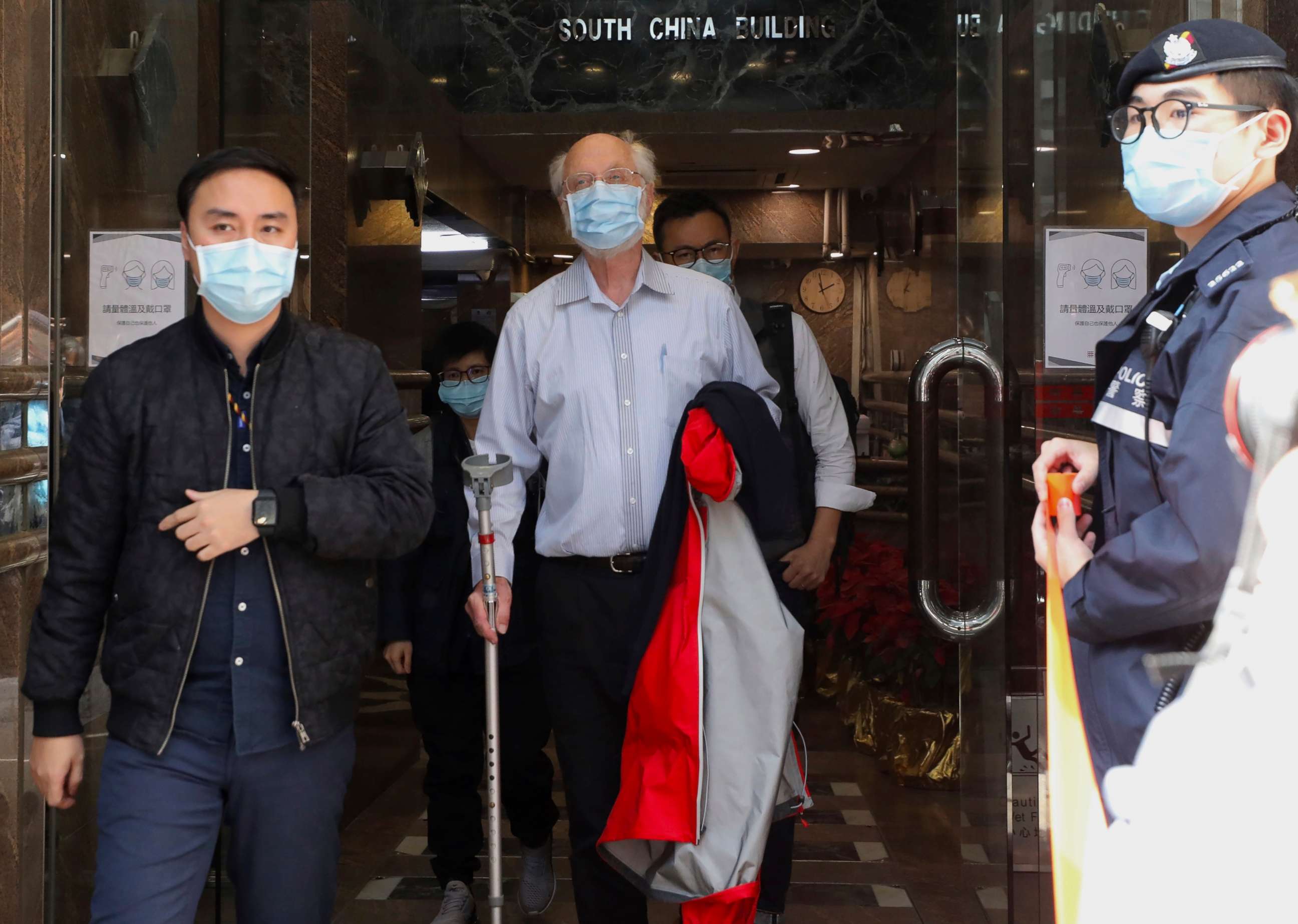 PHOTO: American human rights lawyer John Clancey, center, is arrested by police in Hong Kong on Jan. 6, 2021.