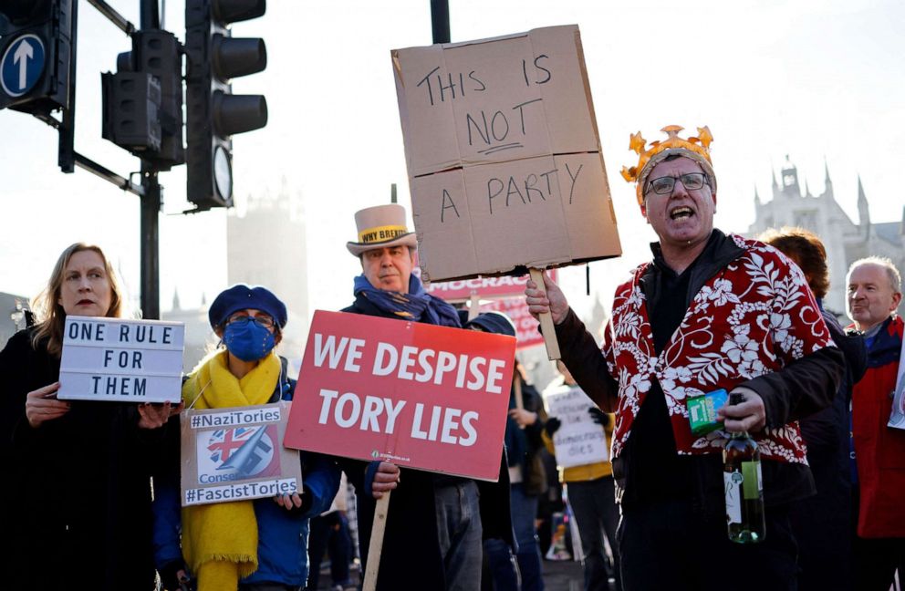 PHOTO: People protest near the House of Commons, where Britain's Prime Minister was taking part in the weekly session of Prime Minister Questions (PMQs) in central London on Jan. 12, 2022.