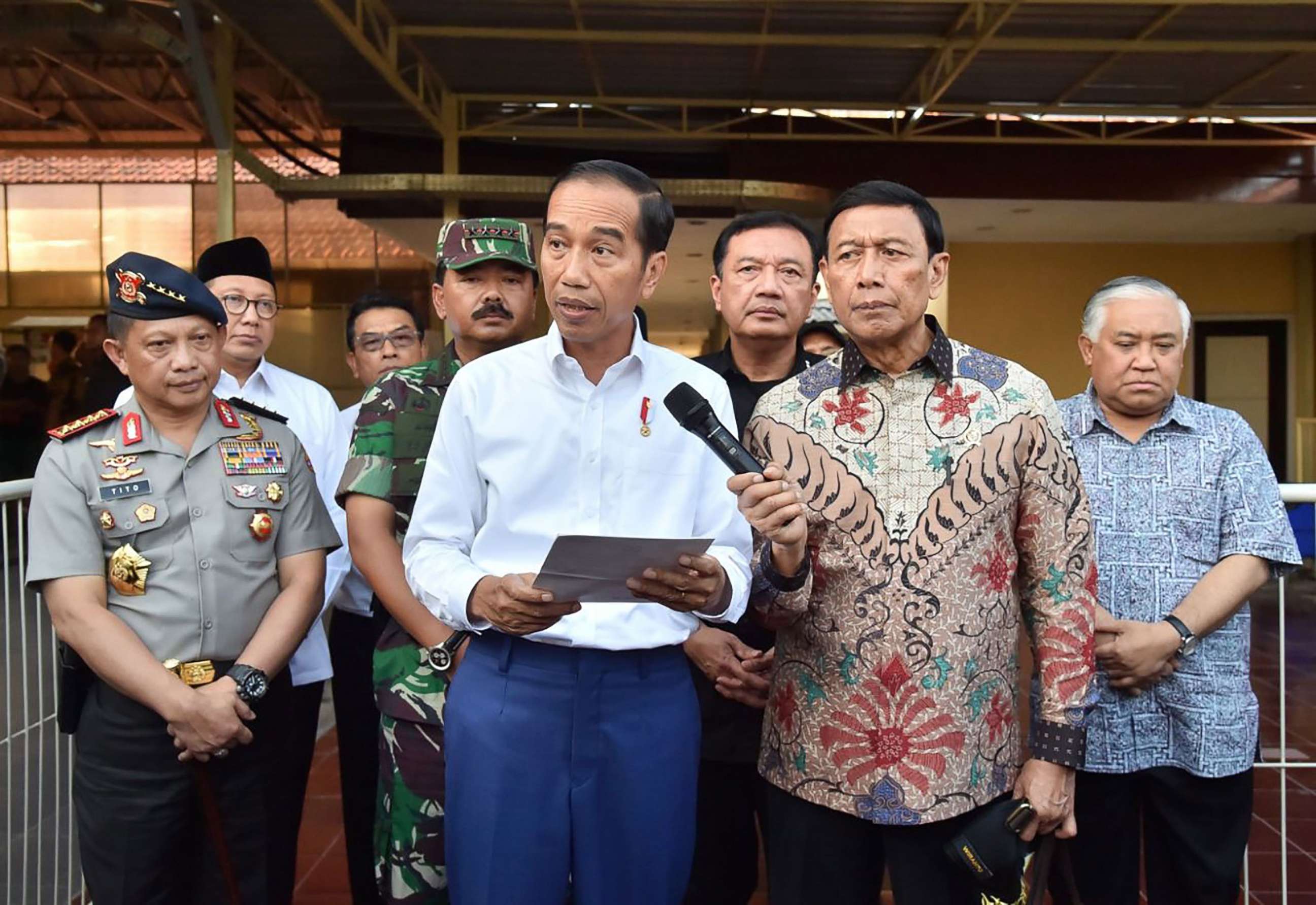 PHOTO: This handout photo released by the Presidential Palace on May 13, 2018 shows Indonesia's President Joko Widodo (C) and other officials holding a press conference in Surabaya after a series of suicide bombings.