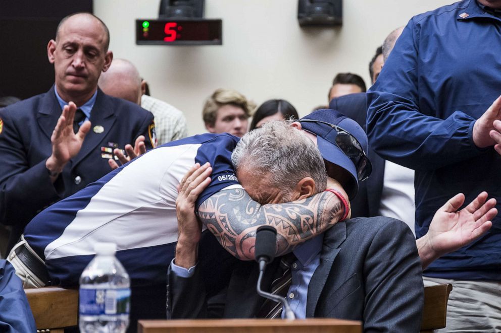 PHOTO: FealGood Foundation co-founder John Feal hugs former Daily Show Host Jon Stewart during a House Judiciary Committee hearing on Capitol Hill, June 11, 2019, in Washington, D.C.