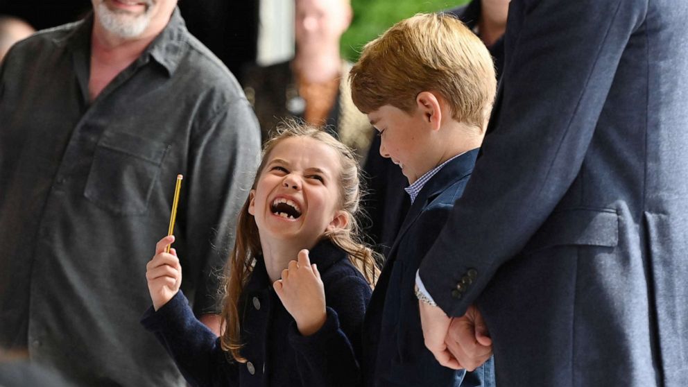 PHOTO: Princess Charlotte laughs as she conducts a band next to her brother Prince George during their visit to Cardiff Castle as part of the royal family's tour for Queen Elizabeth's Platinum Jubilee celebrations in Cardiff, Wales, Britain, June 4, 2022.
