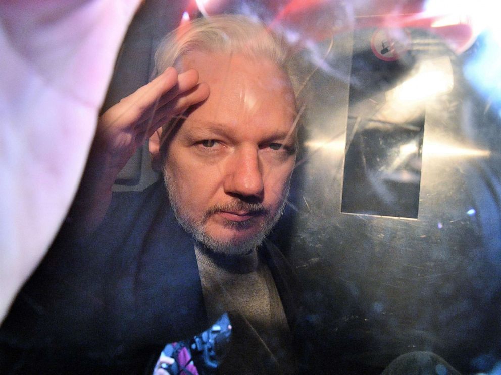 PHOTO: WikiLeaks founder Julian Assange gestures from the window of a prison van as he is driven out of Southwark Crown Court in London on May 1, 2019.