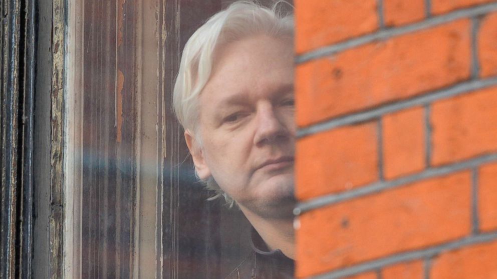 PHOTO: Julian Assange looks out of the window from the balcony of the Embassy Of Ecuador on May 19, 2017 in London.