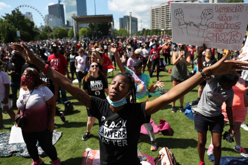 PHOTO: People pray together during a Juneteenth event Organized by the One Race Movement at Centennial Olympic Park, on June 19, 2020, in Atlanta.