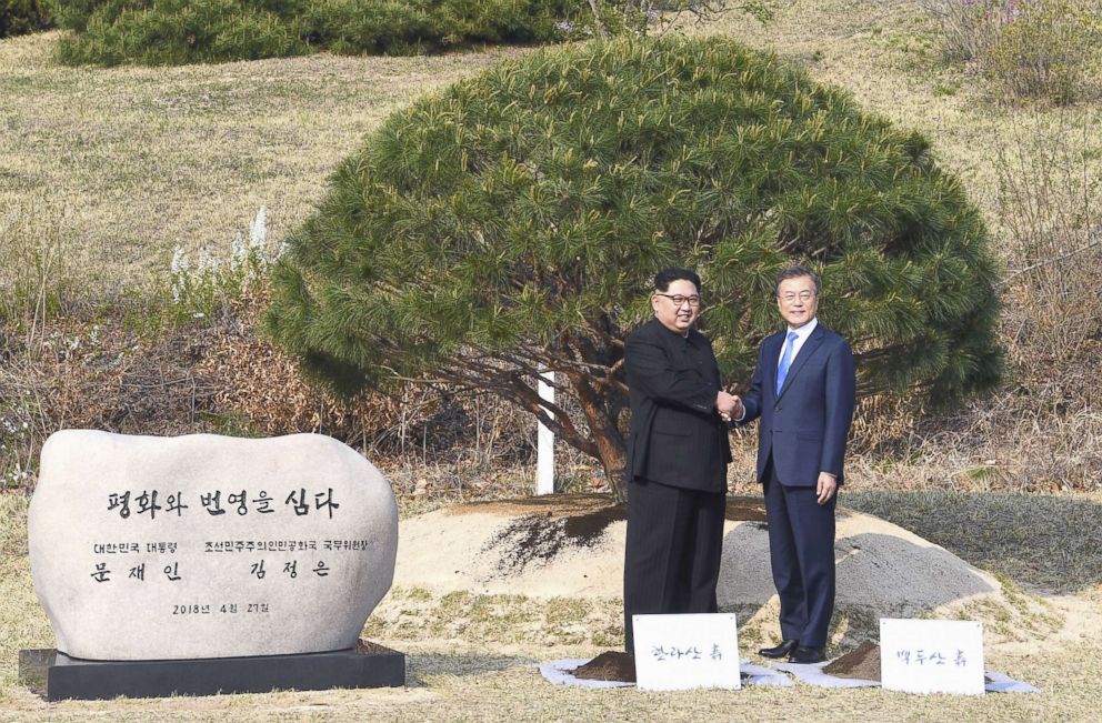 PHOTO: North Korean leader Kim Jong Un and South Korean President Moon Jae In take part in a pine tree planting ceremony in the border village of Panmunjeom, April 27, 2018.