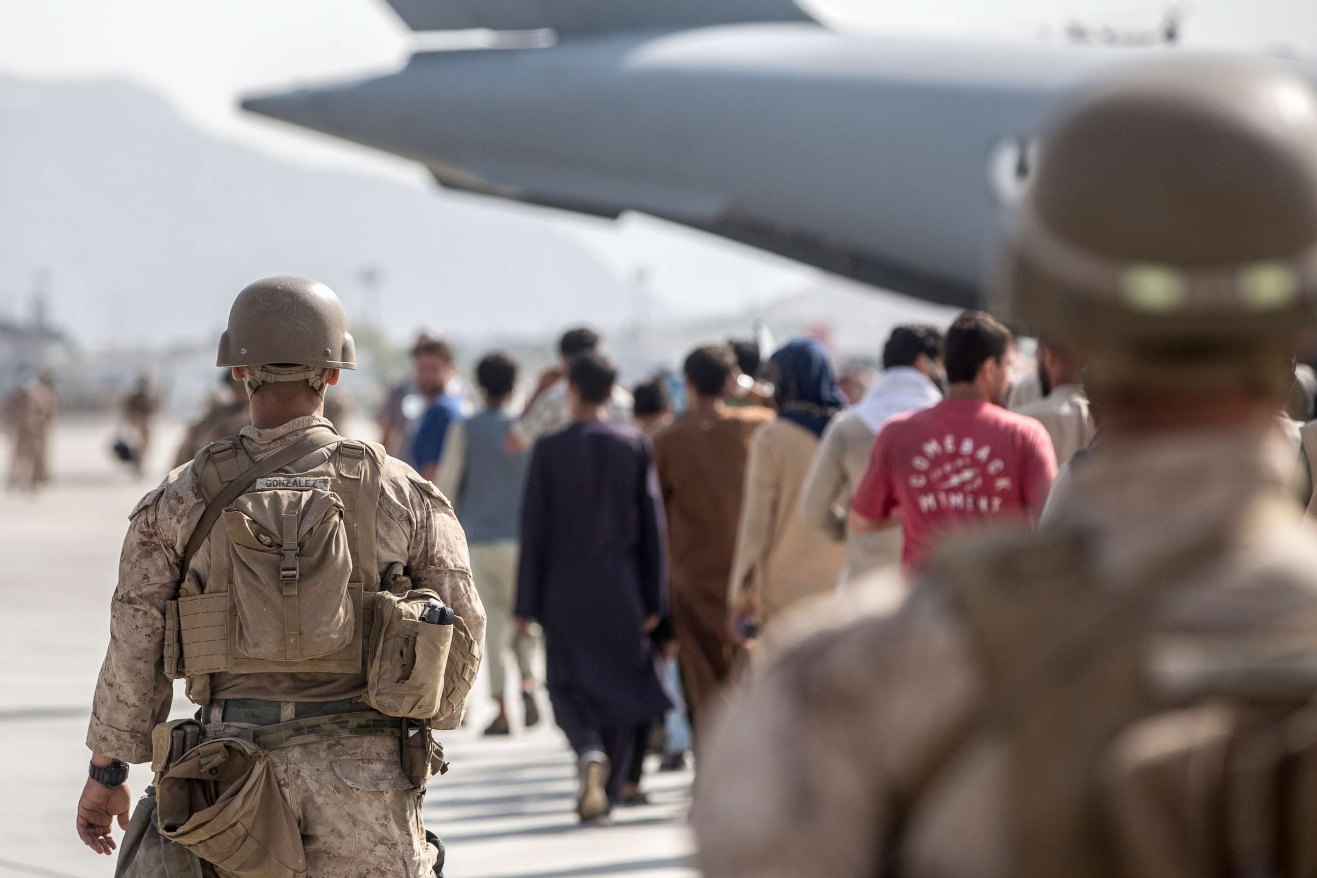 PHOTO: In this Aug. 21, 2021, photo provided by the U.S. Marine Corps, Marines with Special Purpose Marine Air-Ground Task Force-Crisis Response-Central Command guide evacuees on to a U.S. Air Force Boeing C-17 Globemaster III in Kabul, Afghanistan. 