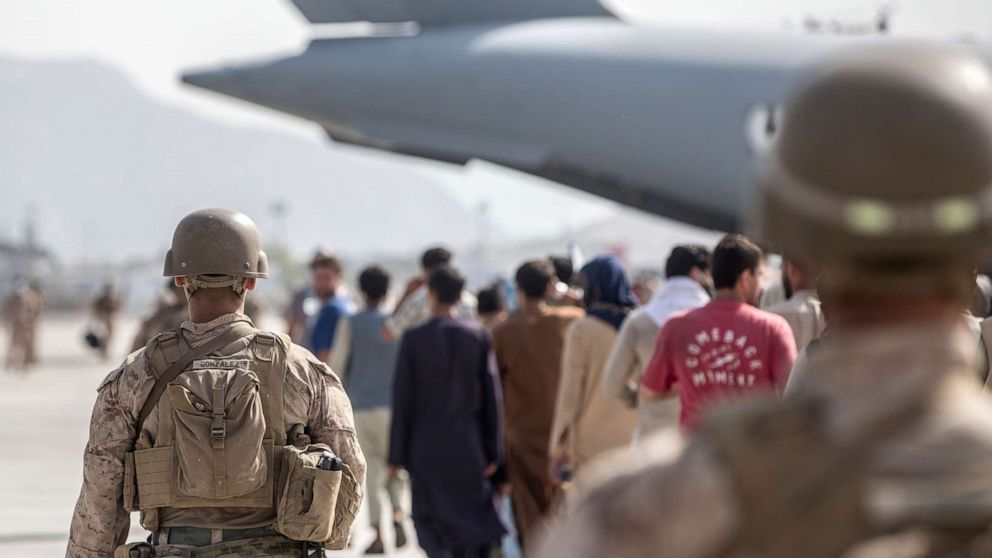 PHOTO: In this Aug. 21, 2021, photo provided by the U.S. Marine Corps, Marines with Special Purpose Marine Air-Ground Task Force-Crisis Response-Central Command guide evacuees on to a U.S. Air Force Boeing C-17 Globemaster III in Kabul, Afghanistan. 