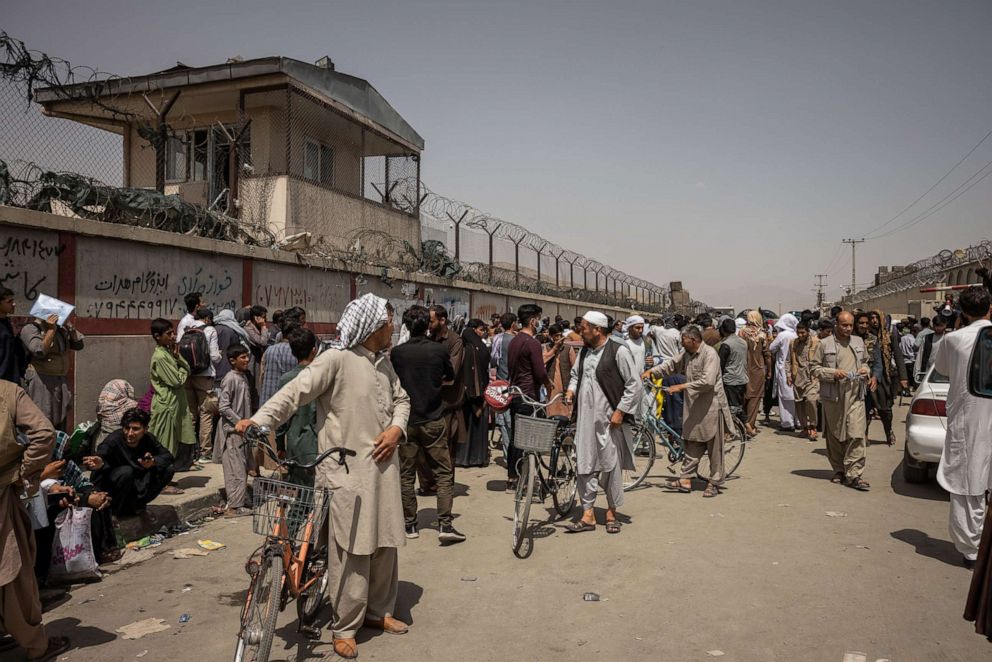 PHOTO: People trying to flee the country gathered at the entrance gates to the international airport in Kabul, Afghanistan, on Aug. 18, 2021.
