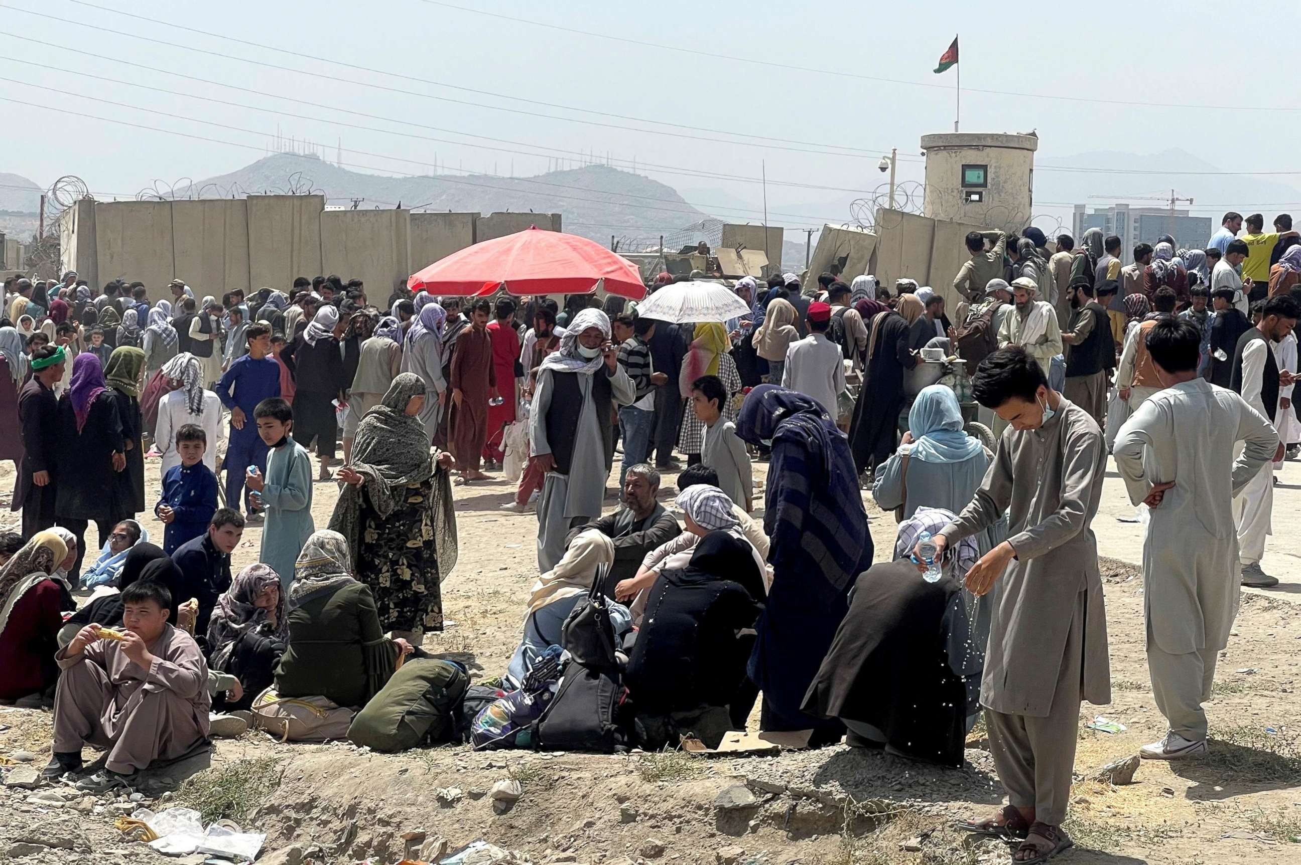 PHOTO: People wait outside Hamid Karzai International Airport in Kabul, Afghanistan, Aug. 17, 2021.