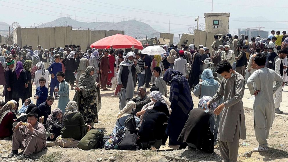 PHOTO: People wait outside Hamid Karzai International Airport in Kabul, Afghanistan, Aug. 17, 2021.