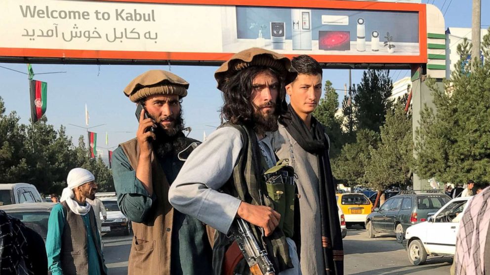 PHOTO: A member of Taliban (C) stands outside Hamid Karzai International Airport in Kabul, Afghanistan, August 16, 2021.