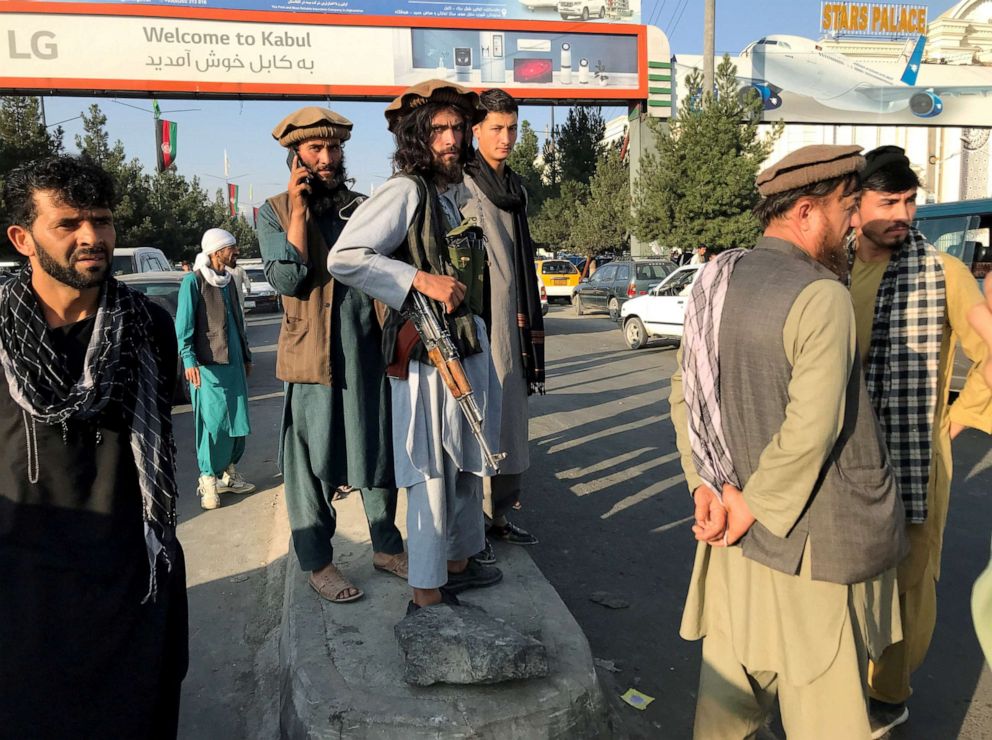 PHOTO: A member of Taliban (C) stands outside Hamid Karzai International Airport in Kabul, Afghanistan, August 16, 2021.