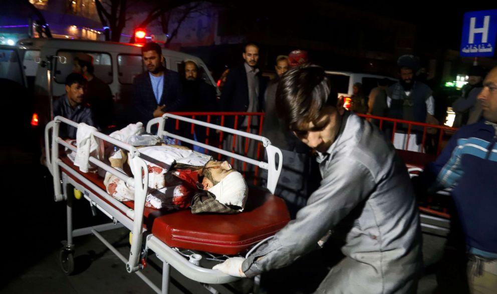 PHOTO: Afghan health workers carry an injured person after a suicide attack targeted a wedding hall in Kabul, Afghanistan, Nov. 20, 2018.