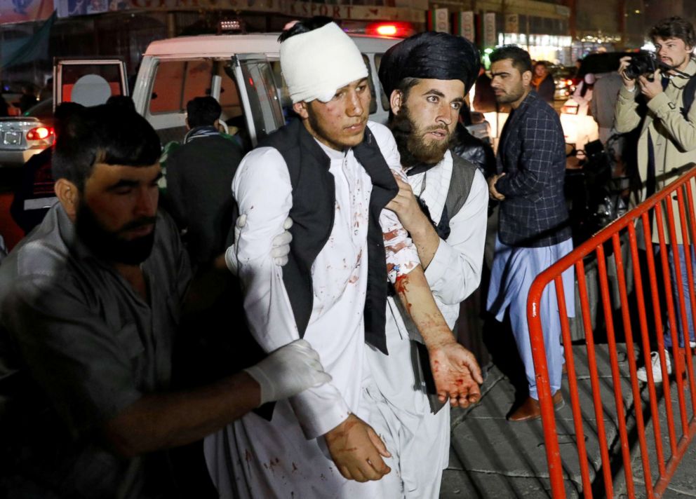 PHOTO: Afghan men carry an injured person to a hospital after a suicide attack in Kabul, Afghanistan, Nov. 20, 2018.