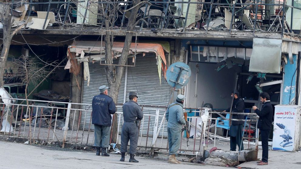 Afghan policemen inspect the site of a bomb attack in Kabul, Afghanistan, Jan. 28, 2018. 