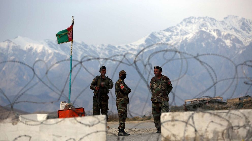 PHOTO: Afghan National Army soldiers stand guard at a checkpoint near the Bagram base in northern Kabul, April 8, 2020.