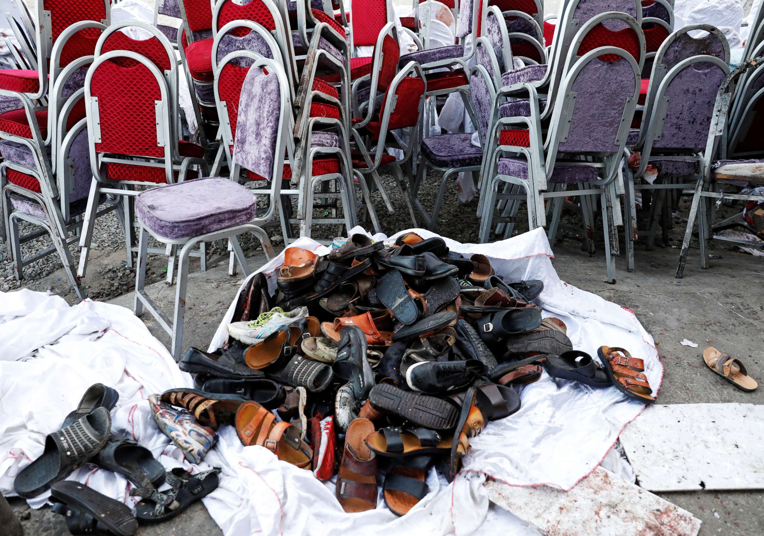 PHOTO: The shoes of victims are seen outside a damaged wedding hall after a blast in Kabul, Afghanistan, on Saturday, Aug. 18, 2019.
