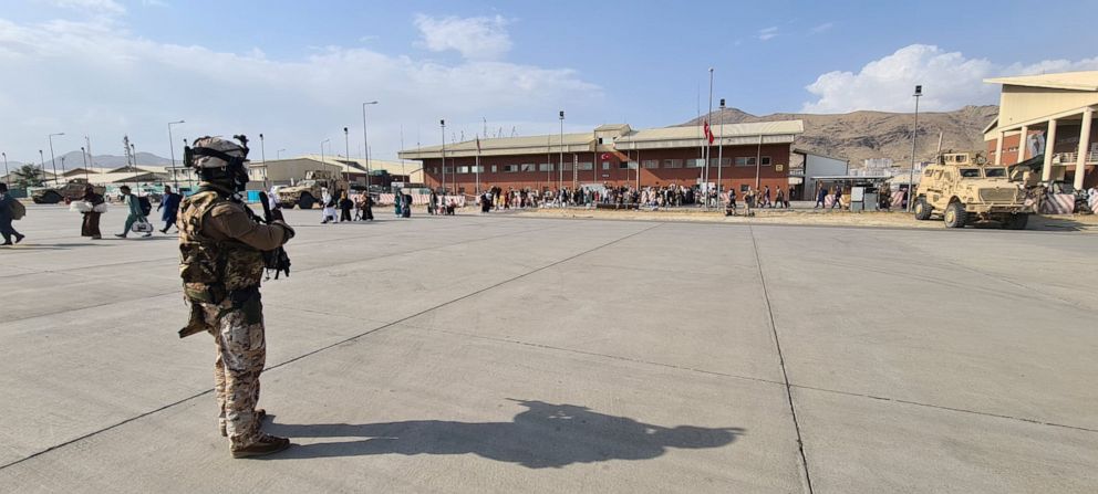 PHOTO: Afghan evacuees queue before boarding Italy's military aircraft?C130J?during evacuation at Kabul's?airport, Afghanistan, August 22, 2021