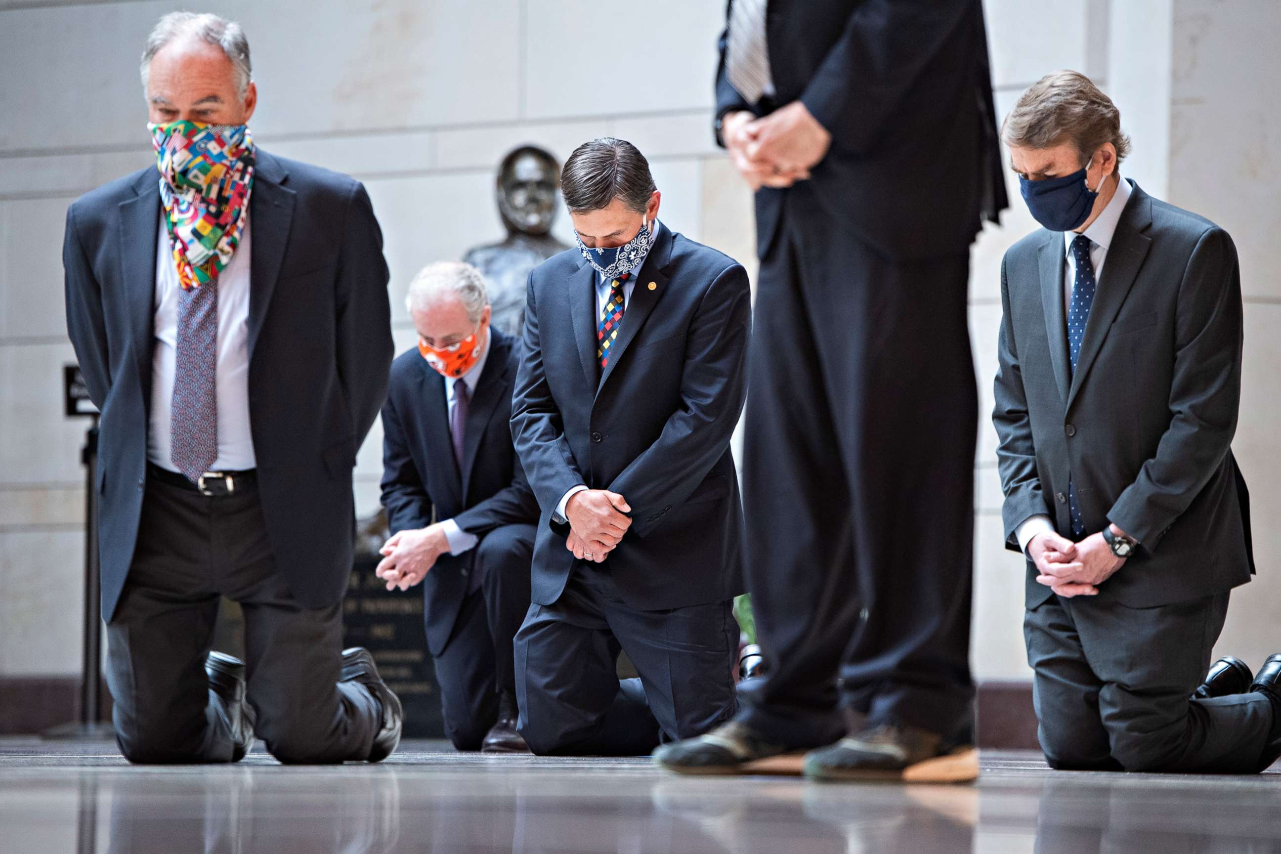 PHOTO: Senators kneel during a moment of silence with Senate Democrats to protest the deaths of George Floyd, Ahmaud Arbery, Breonna Taylor and other victims of racial injustice in the Capitol's Emancipation Hall, June 4, 2020.