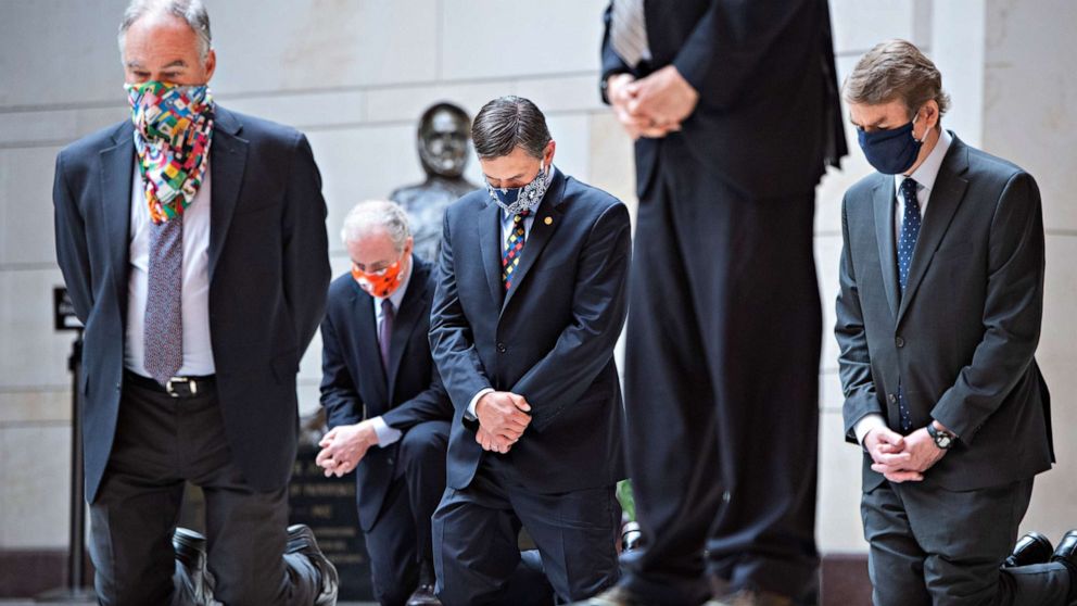 PHOTO: Senators kneel during a moment of silence with Senate Democrats to protest the deaths of George Floyd, Ahmaud Arbery, Breonna Taylor and other victims of racial injustice in the Capitol's Emancipation Hall, June 4, 2020.