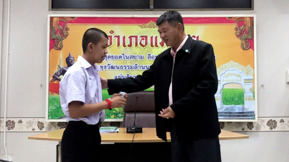 PHOTO: Pornchai Kamluang, left, receives an identity card denoting Thai citizenship from Somsak Kunkam, Sheriff of Mae Sai during a ceremony in Chiang Rai province, Thailand, Aug. 8, 2018.
