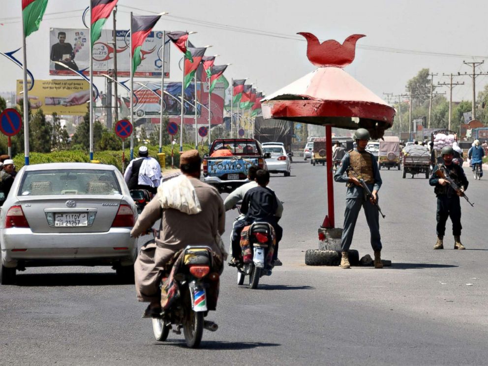 PHOTO: Afghan policemen stand guard at a checkpoint ahead of parliamentary election in Kandahar on Oct. 18, 2018.