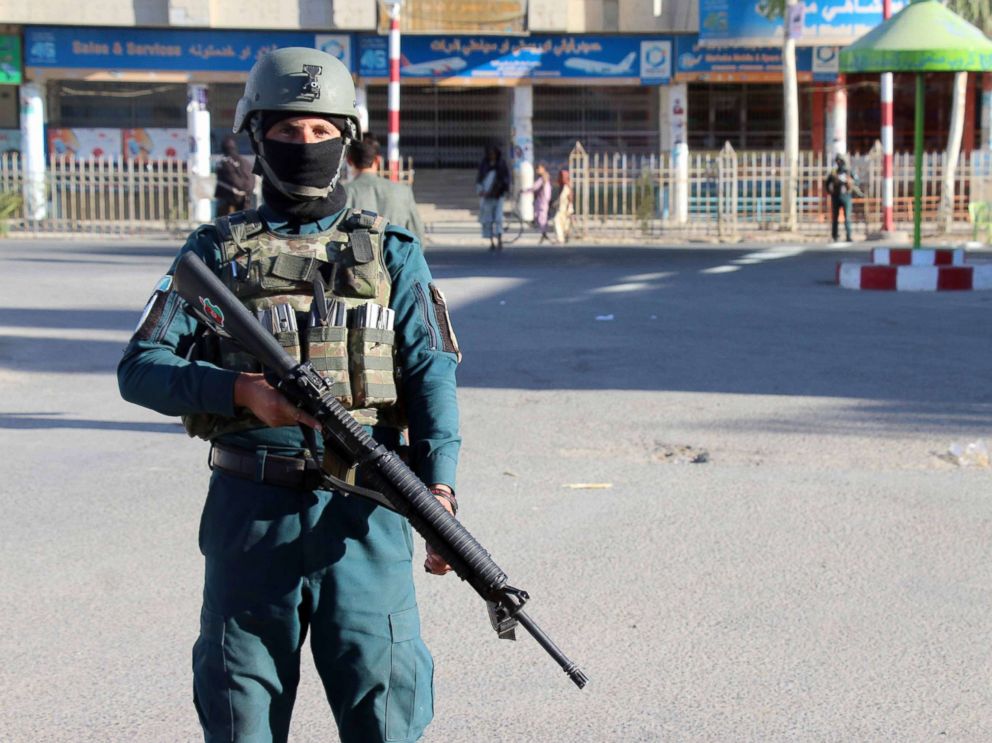 PHOTO: Afghan security officials stand guard on a road as security has been intensified a day after a Taliban militant killed General Abdul Razzaq Dawood, an Afghan Police commander, in Kandahar, Afghanistan, Oct. 19, 2018.