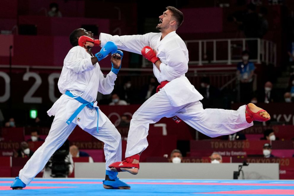 PHOTO: Tareg Hamedi of Saudi Arabia, left, and Ivan Kvesic of Croatia compete in the men's kumite +75kg elimination round for karate at the 2020 Summer Olympics, Aug. 7, 2021, in Tokyo, Japan.