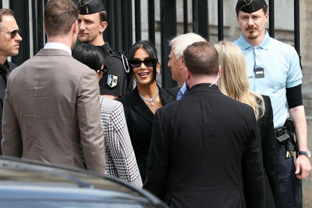 PHOTO: Kim Kardashian, center, arrives at the Assize Court for the trial during which she will testify over the 2016 robbery that saw her relieved of millions of dollars' worth of jewellery at gunpoint, in Paris, on May 13, 2025. 
