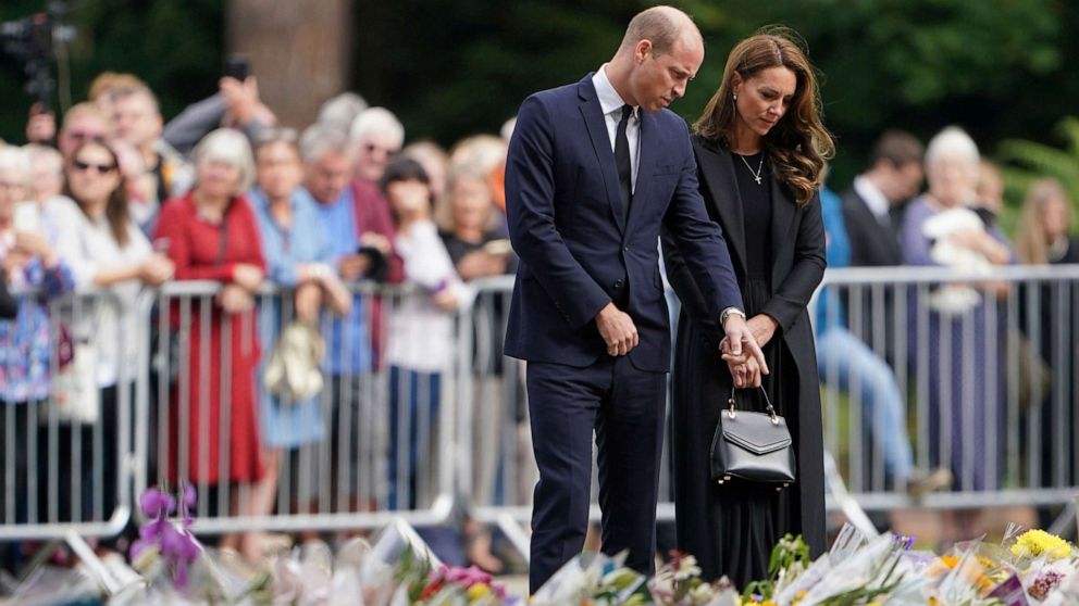 PHOTO: Prince William and the Princess of Wales look at floral tributes to the late Queen Elizabeth II presented by members of the public outside the gates of Sandringham House in Norfolk Sept. 15, 2022.