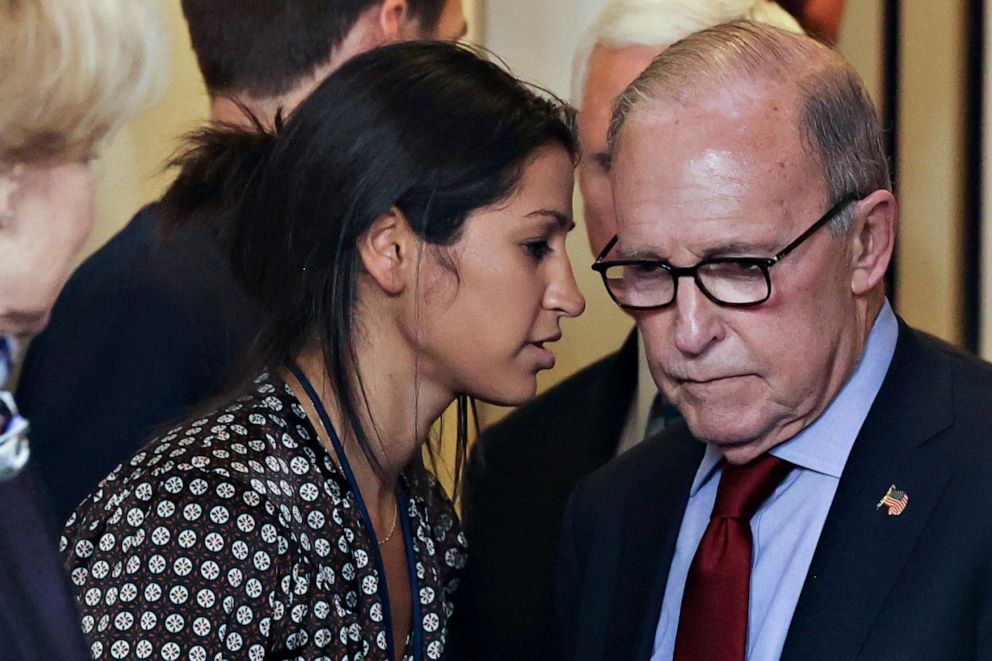 PHOTO: Katie Miller, press secretary for Vice President Mike Pence, speaks to White House chief economic adviser Larry Kudlow before the daily coronavirus task force briefing at the White House, in Washington, March 10, 2020.