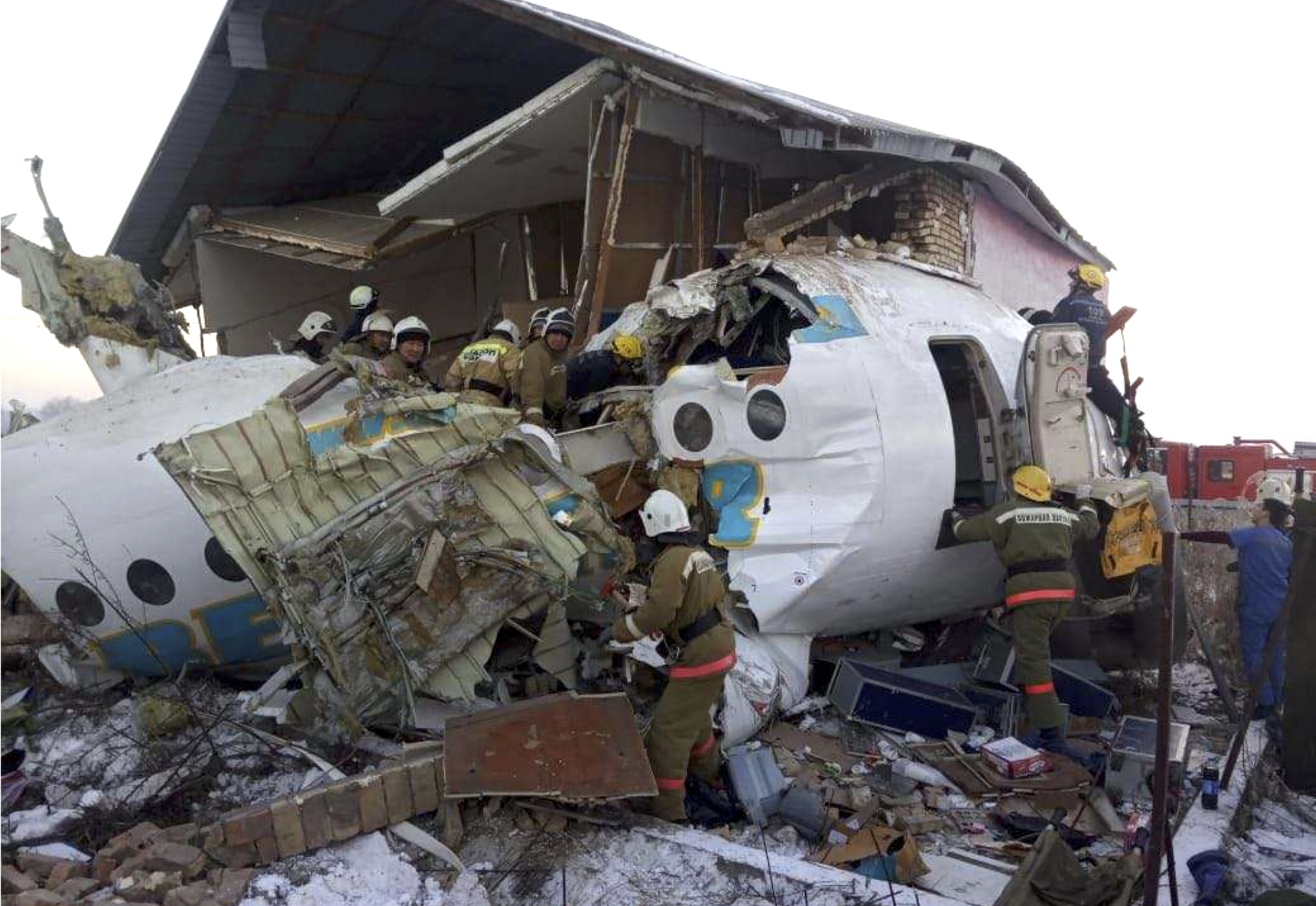 PHOTO: In this handout photo provided by the Emergency Situations Ministry of the Republic of Kazakhstan, police and rescuers work on the side of a plane crash near Almaty International Airport, outside Almaty, Kazakhstan, Friday, Dec. 27, 2019. 