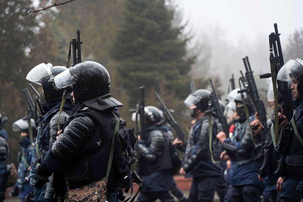 PHOTO: Riot police officers hold their weapons ready as they try to stop demonstrators during a protest in Almaty, Kazakhstan, Jan. 5, 2022. 