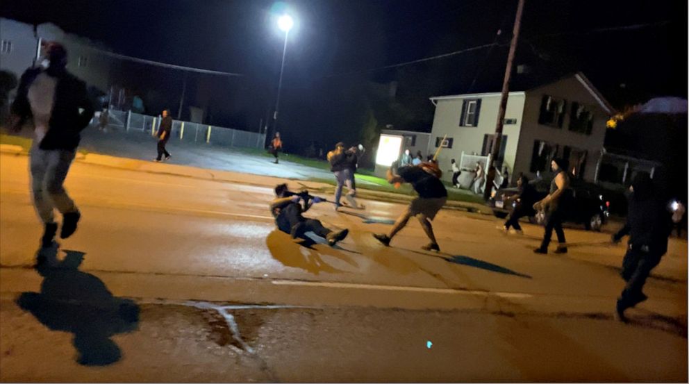 PHOTO: A man identified by police as Kyle Rittenhouse is seen lying on the ground and firing at least four shots. Two people, Anthony Huber and Gaige Grosskreutz (seen bent over) were struck. Joseph Rosenbaum was shot minutes earlier.