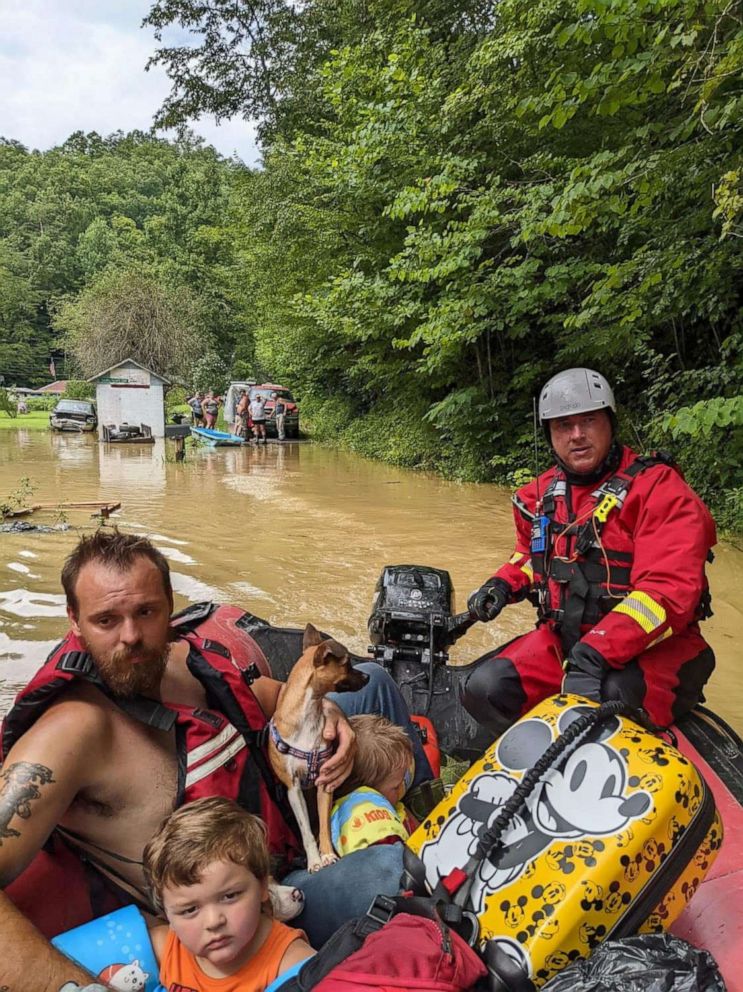 PHOTO: A rescue team member evacuates residents from their homes in a boat through flooded streets, in Breathitt County, Ky., on July 28, 2022.