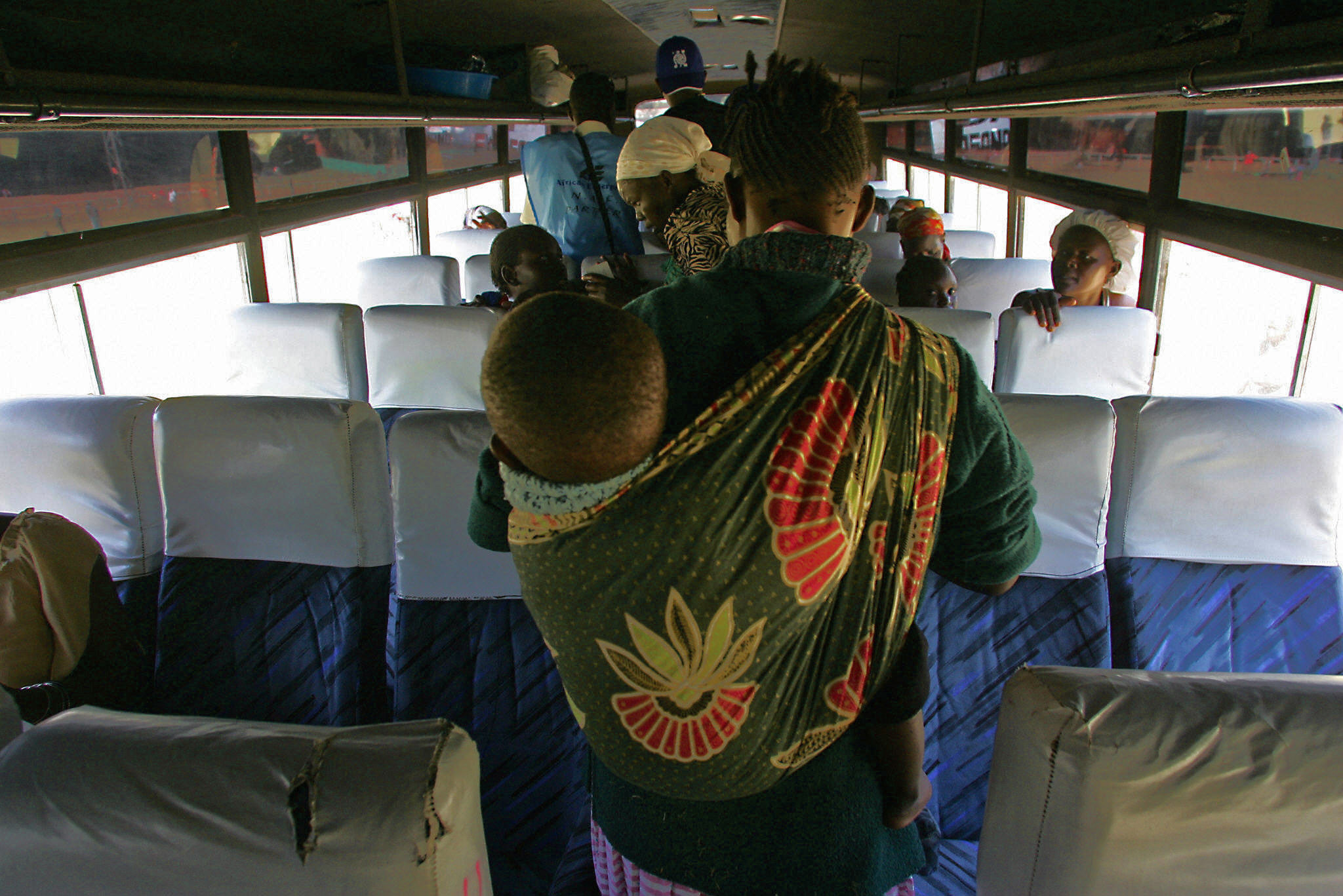 PHOTO: A mother carrying her baby looks for a seat in bus in Nairobi, Kenya, Jan. 25, 2008.