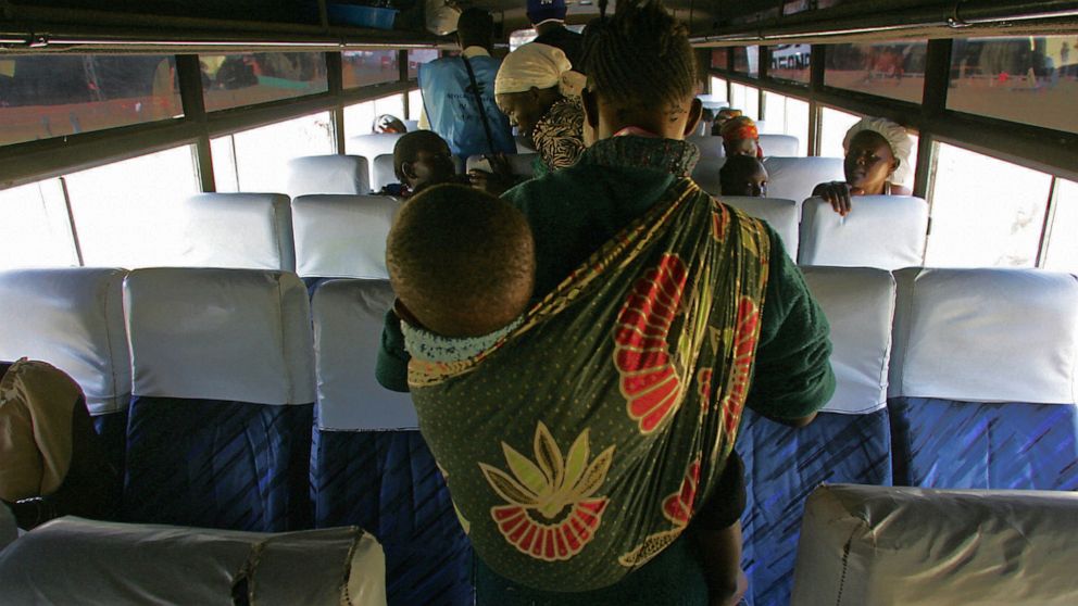 PHOTO: A mother carrying her baby looks for a seat in bus in Nairobi, Kenya, Jan. 25, 2008.