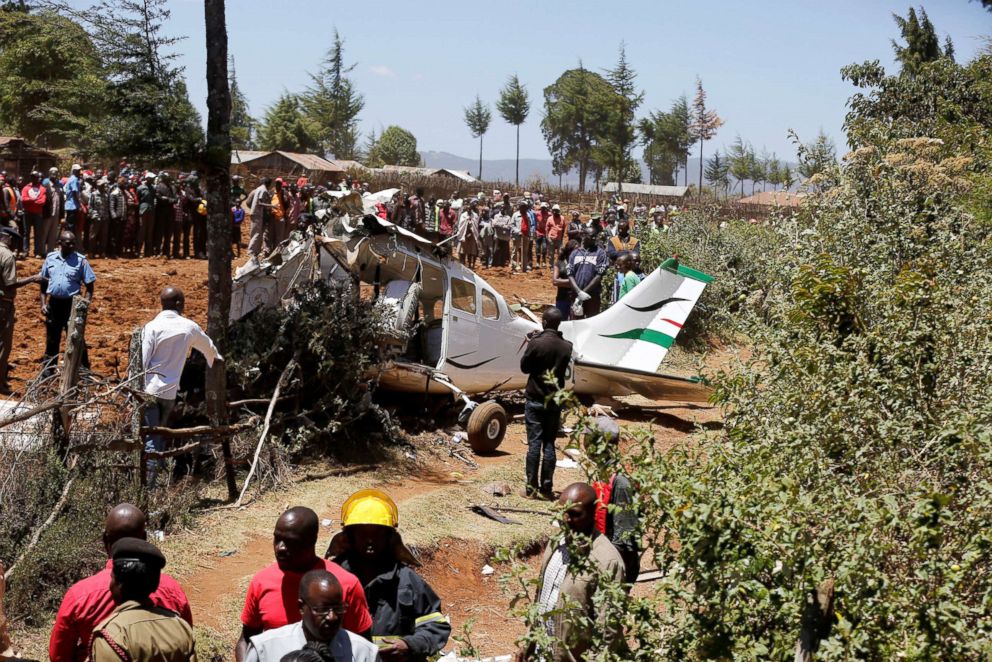 PHOTO: Rescuers and bystanders gather near the wreckage of a Cessna 206 light aircraft that crashed with its Kenyan pilot and four foreign passengers at an agricultural farm in Londiani, Kenya Feb.13, 2019.