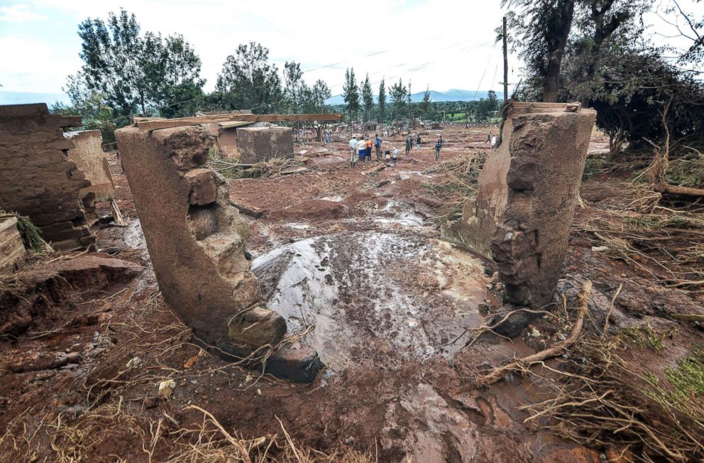 PHOTO: People walk among houses that were  destroyed by flood water after the Petal dam burst its banks near the town of Solai, Kenya, May 10, 2018.