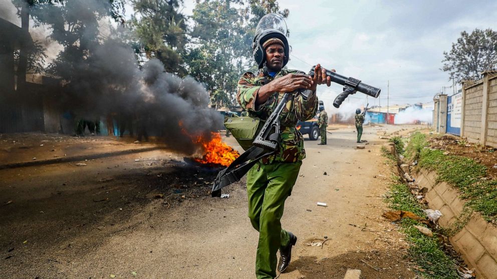 PHOTO: A riot policeman reloads a teargas grenade launcher during clashes with protesters in the Kibera area of Nairobi, Kenya, July 19, 2023.