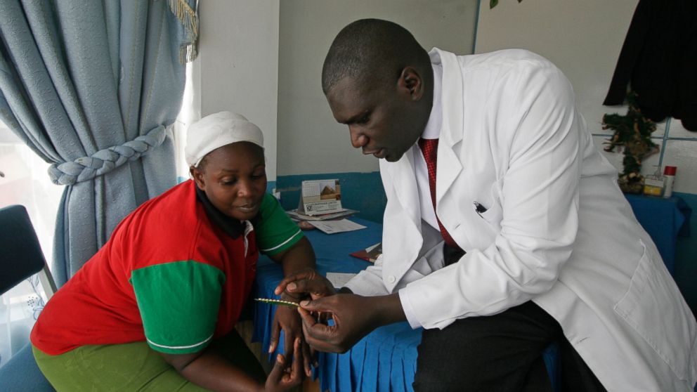 Dr. Aron Sikuku explains family planning pills to Beatrice Ravonga in Nairobi, Kenya. President Donald Trump's move a year ago to expand cuts in U.S. funding to foreign organizations providing abortion has left women without access to treatment.