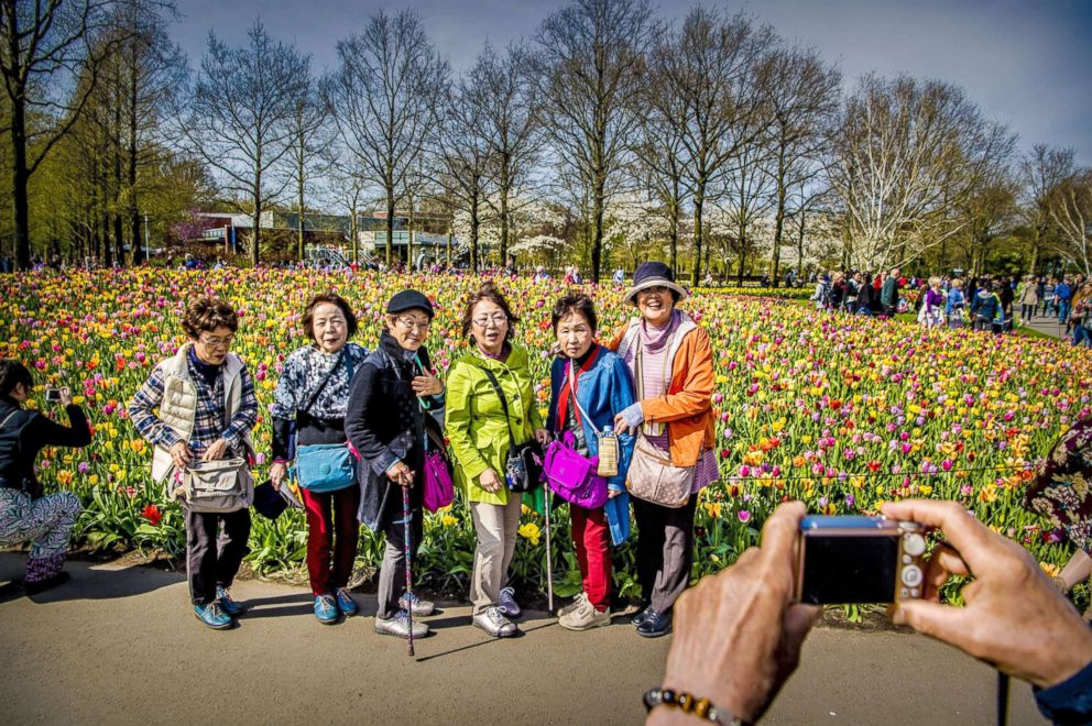 PHOTO: Visitors take pictures against the Keukenhof the tulip fields in Lisse, The Netherlands, April 17, 2018.