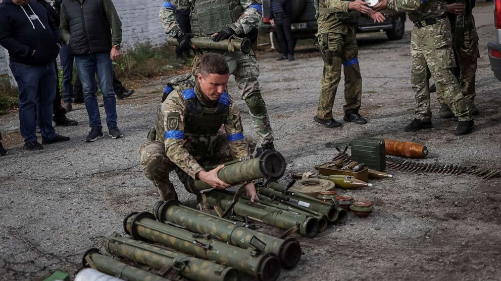 PHOTO: A police sapper sorts unexploded mine shells and weapons after return from the village of Udy, recently liberated by Ukrainian Armed Forces, in the town of Zolochiv, Kharkiv region, Ukraine, Sept. 12, 2022. 