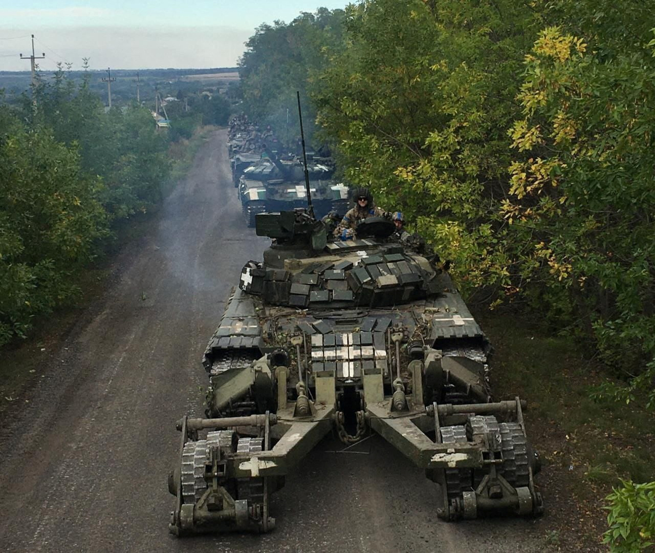 PHOTO: Ukrainian service members ride on tanks during a counteroffensive operation, amid Russia's attack on Ukraine, in Kharkiv region, Ukraine, in this handout picture released Sept. 12, 2022.