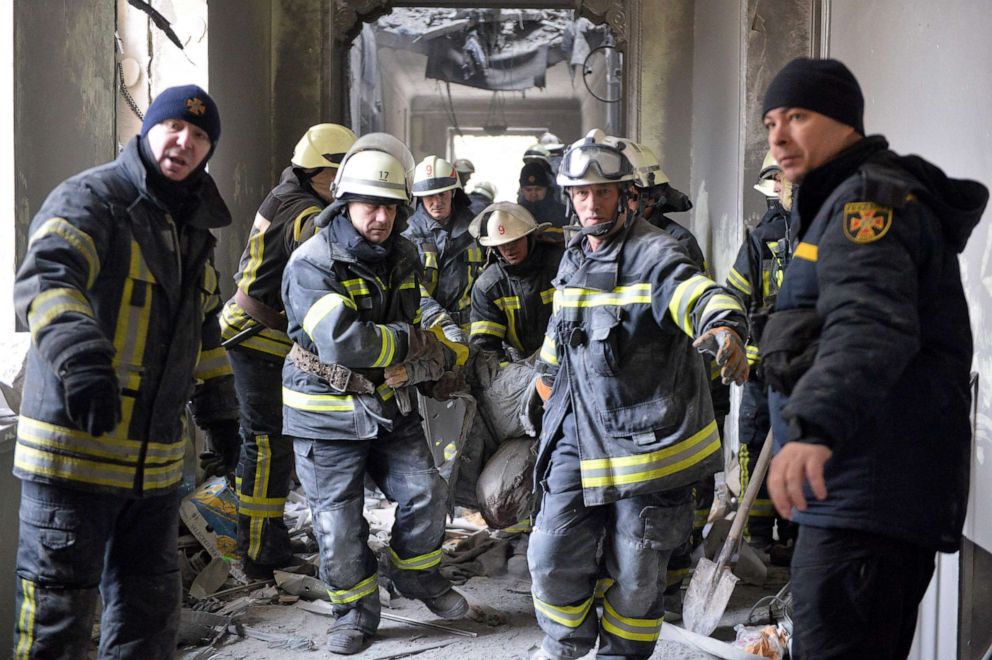PHOTO: Emergency personnel carry a body out of the damaged local city hall of Kharkiv, March 1, 2022, destroyed by Russian shelling.
