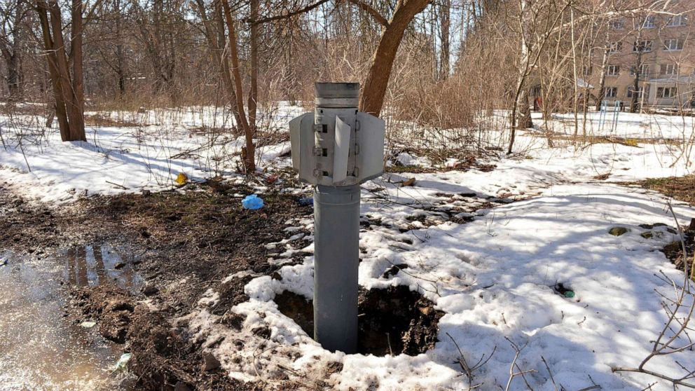 PHOTO: An unexploded Russian rocket is seen in the ground after shelling on the northern outskirts of Kharkiv, March 21, 2022.