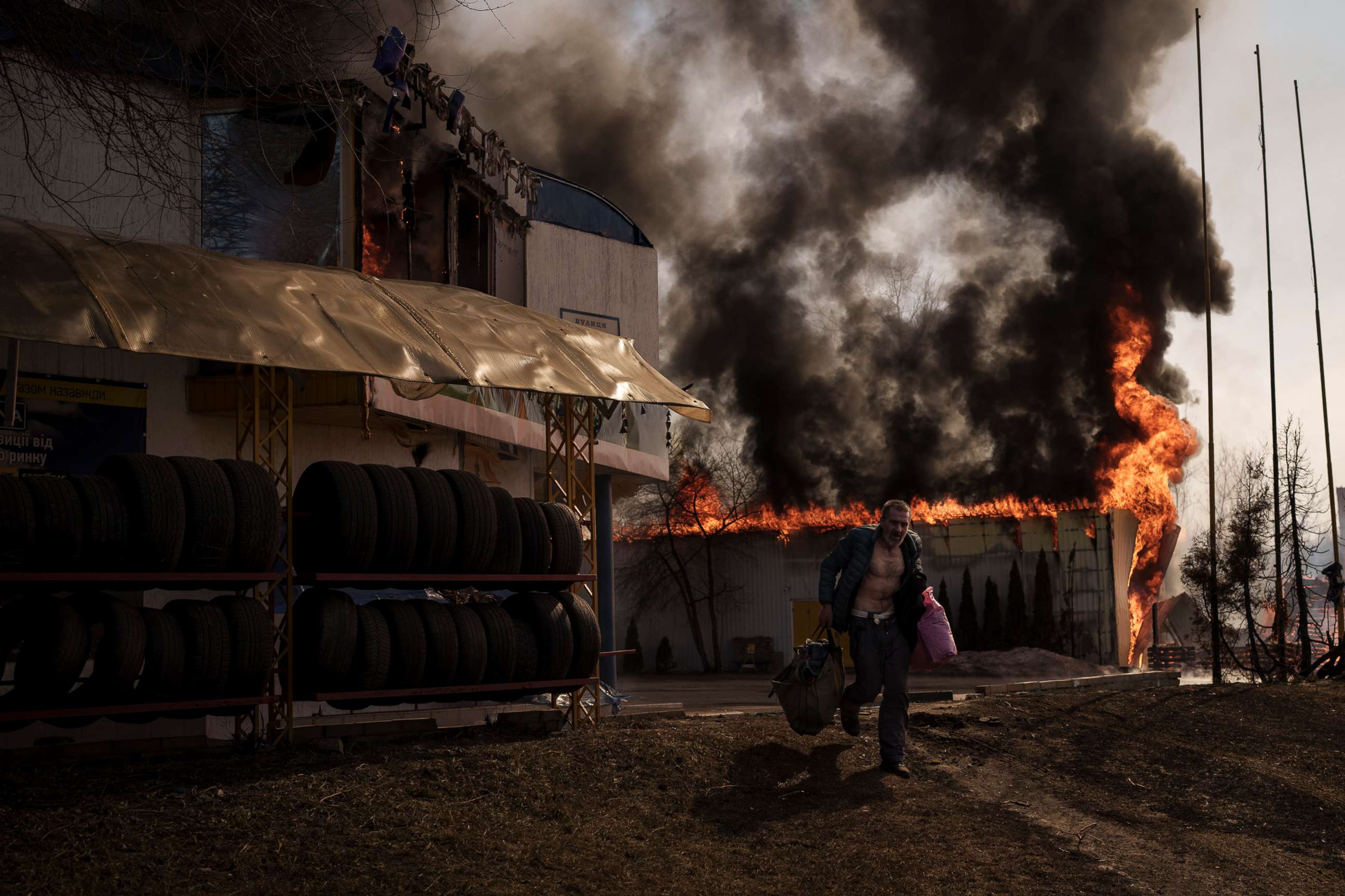 PHOTO: A man recovers items from a burning shop following a Russian attack in Kharkiv, Ukraine, March 25, 2022.