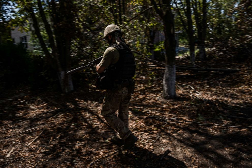 PHOTO: Call sign Bury walks in one of the villages near the Kherson frontline in Mykolaiv region, Ukraine, Aug. 8, 2022.