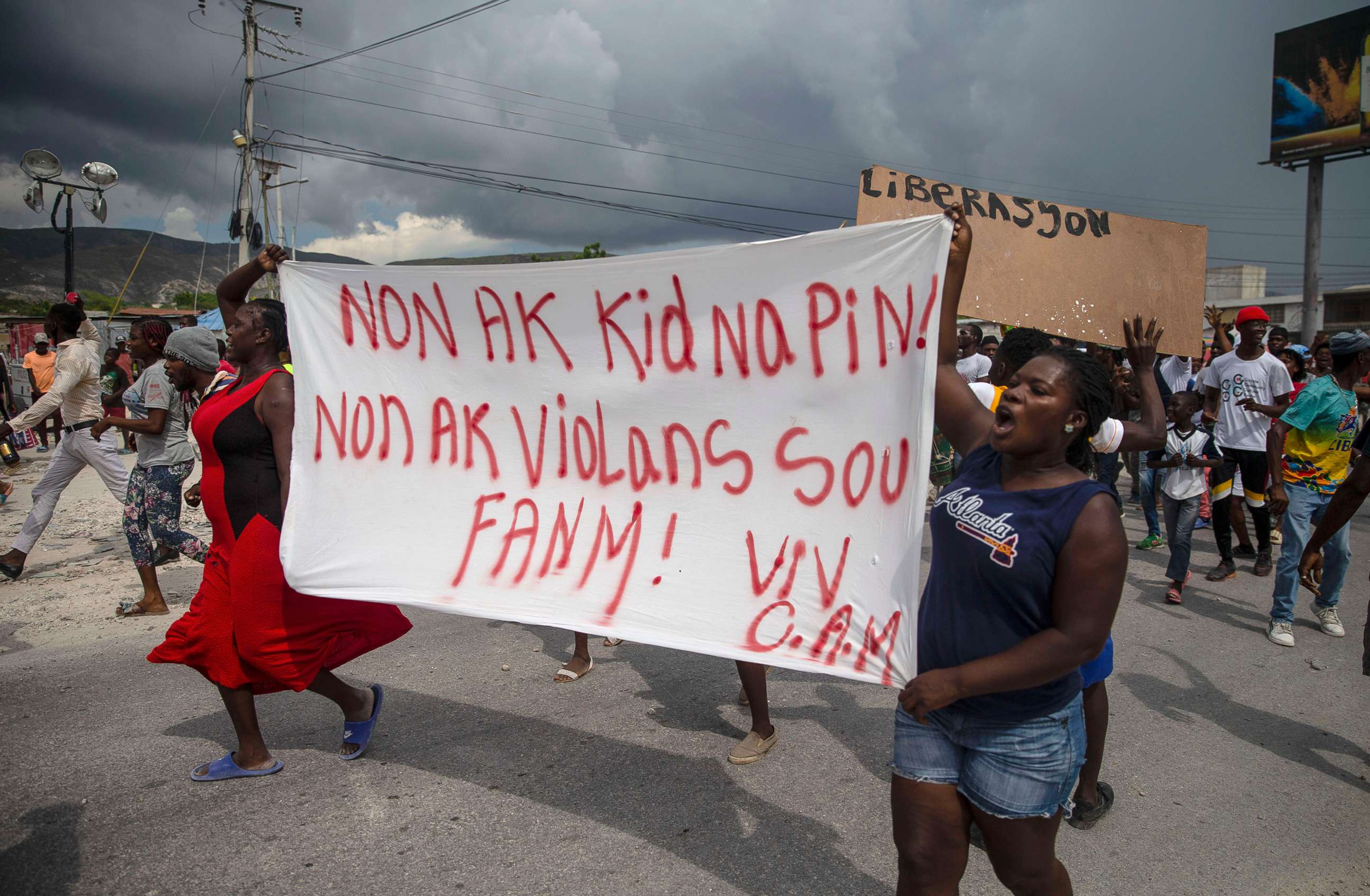 PHOTO: People protest carrying a banner with a message in Creole demanding the release of kidnapped missionaries, in Titanyen, north of Port-au-Prince, Haiti, Oct. 19, 2021.