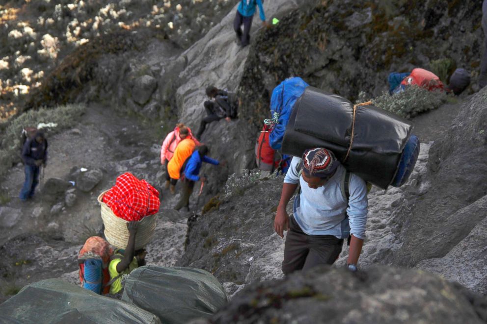   PHOTO: The group is led by porters climbing Barranco Wall, a steep climb on Kilimanjaro 